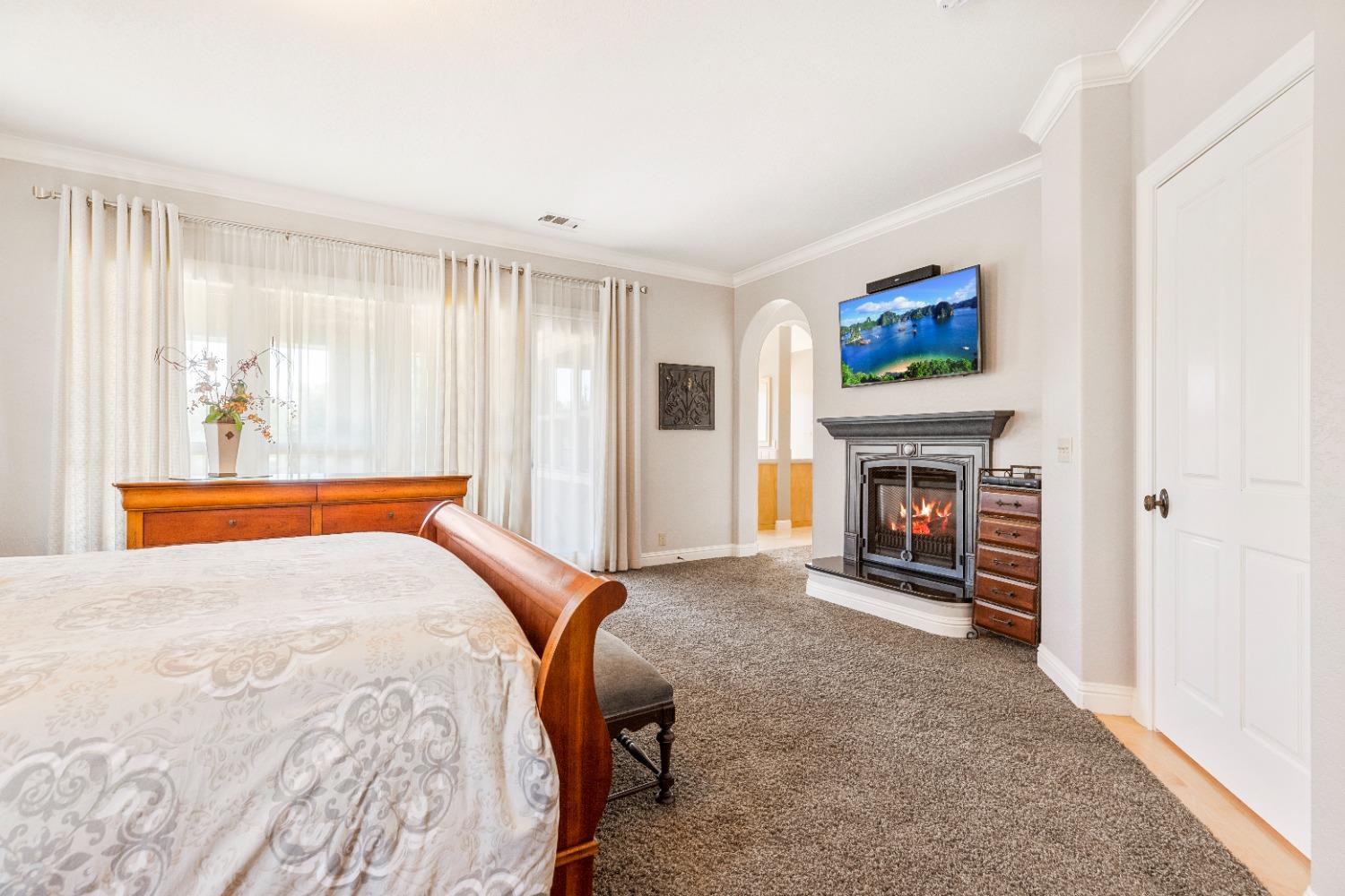 618 Elfers Road Patterson, CA 95363 - Photo 56 of 79 a bedroom with a bed and a fireplace