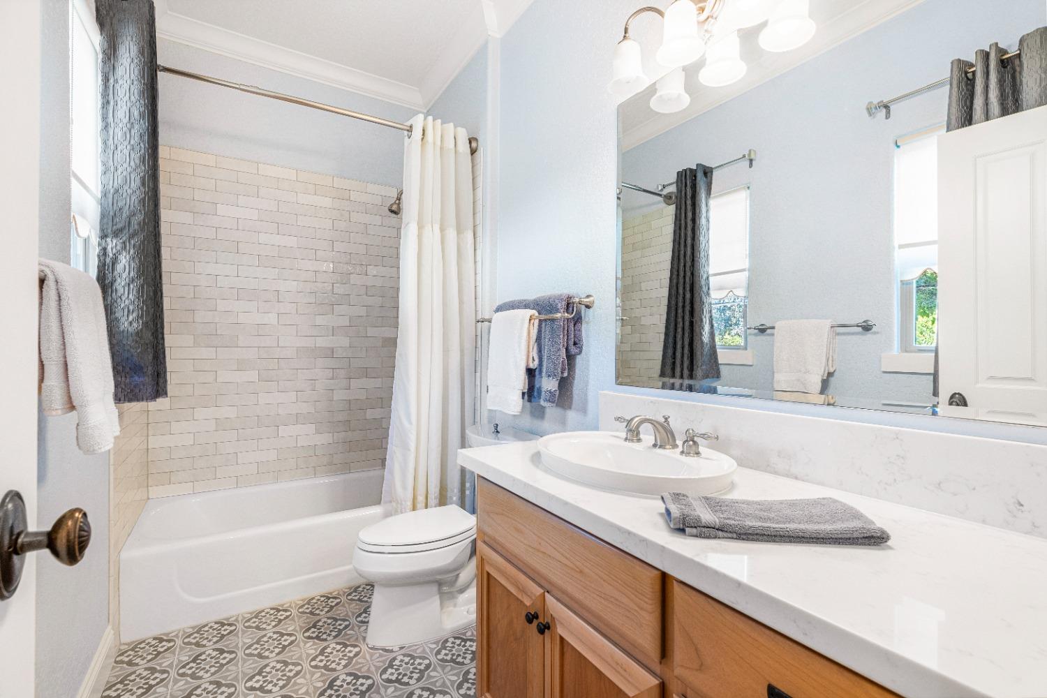 618 Elfers Road Patterson, CA 95363 - Photo 64 of 79 a bathroom with a granite countertop sink toilet and shower