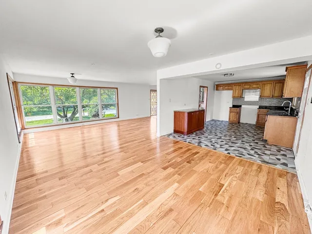 a kitchen with stainless steel appliances a sink a stove a refrigerator and cabinets