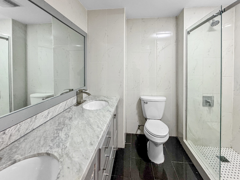 15831 Trumbull Avenue Markham, IL 60428 - Photo 9 of 25 a bathroom with a granite countertop toilet and a sink