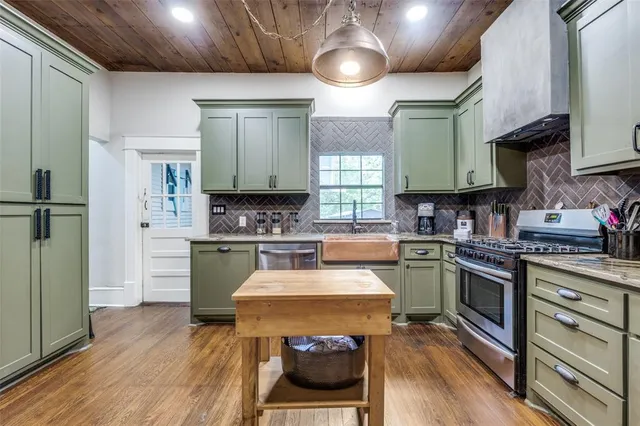 a kitchen with a stove a sink and a refrigerator