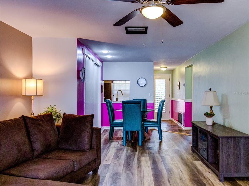 Undisclosed Address New Port Richey, FL 34652 - Photo 16 of 48 a living room with furniture and wooden floor