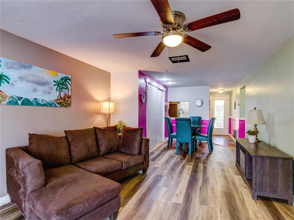 Undisclosed Address New Port Richey, FL 34652 - Photo 17 of 48 a living room with furniture kitchen view and a wooden floor