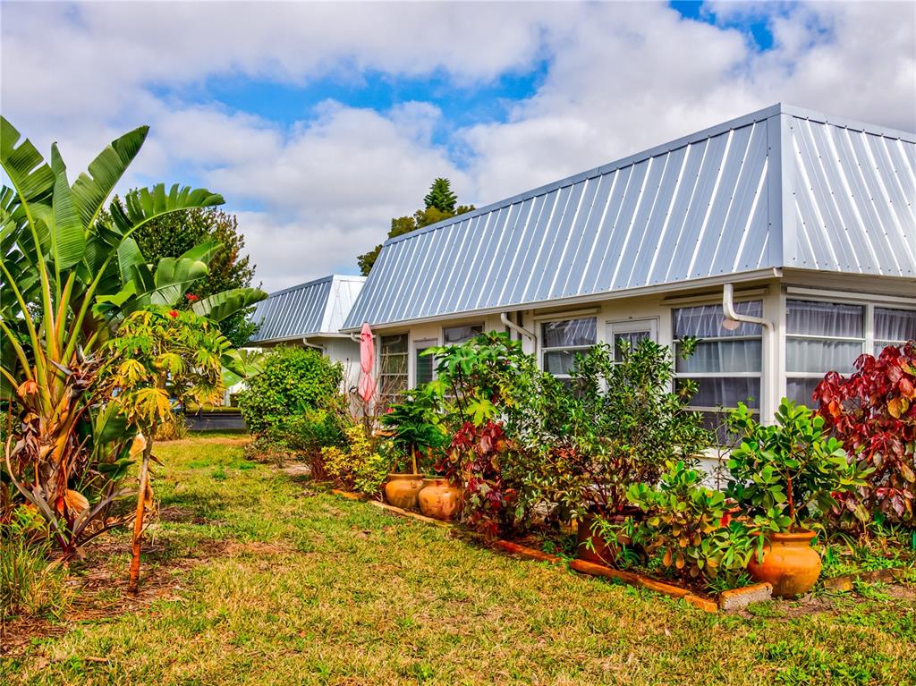 Undisclosed Address New Port Richey, FL 34652 - Photo 36 of 48 a view of a house with a flower garden in front of it