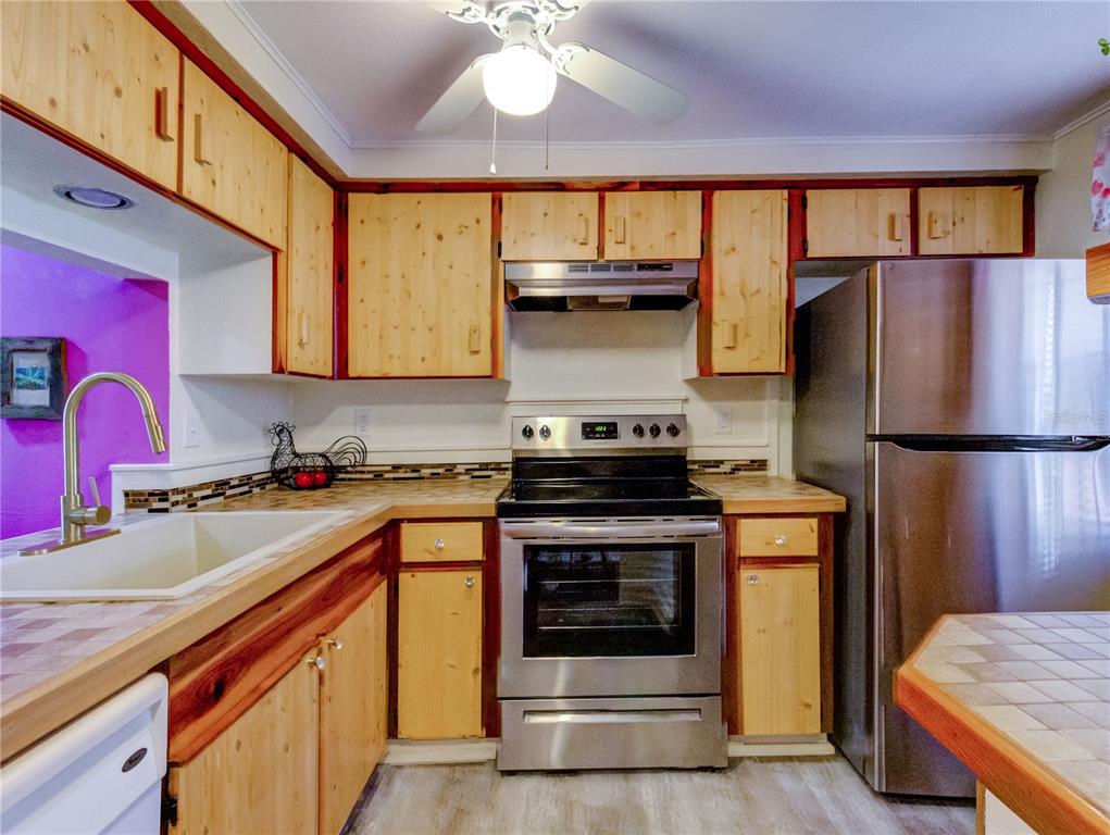 Undisclosed Address New Port Richey, FL 34652 - Photo 10 of 48 a kitchen with a stove and a refrigerator