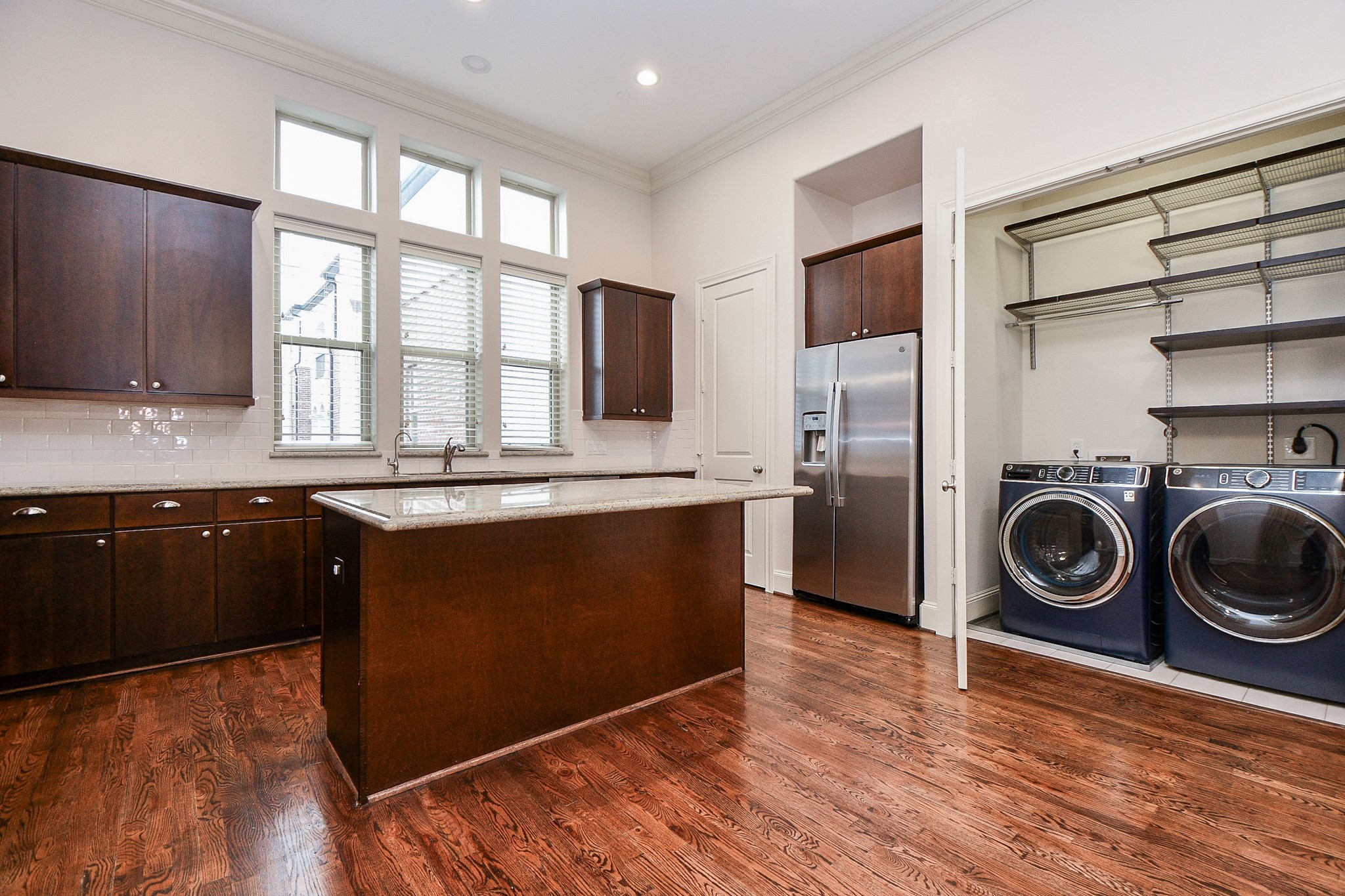 709 Delano Street Houston, TX 77003 - Photo 11 of 36 a kitchen with granite countertop a stove a sink and a refrigerator