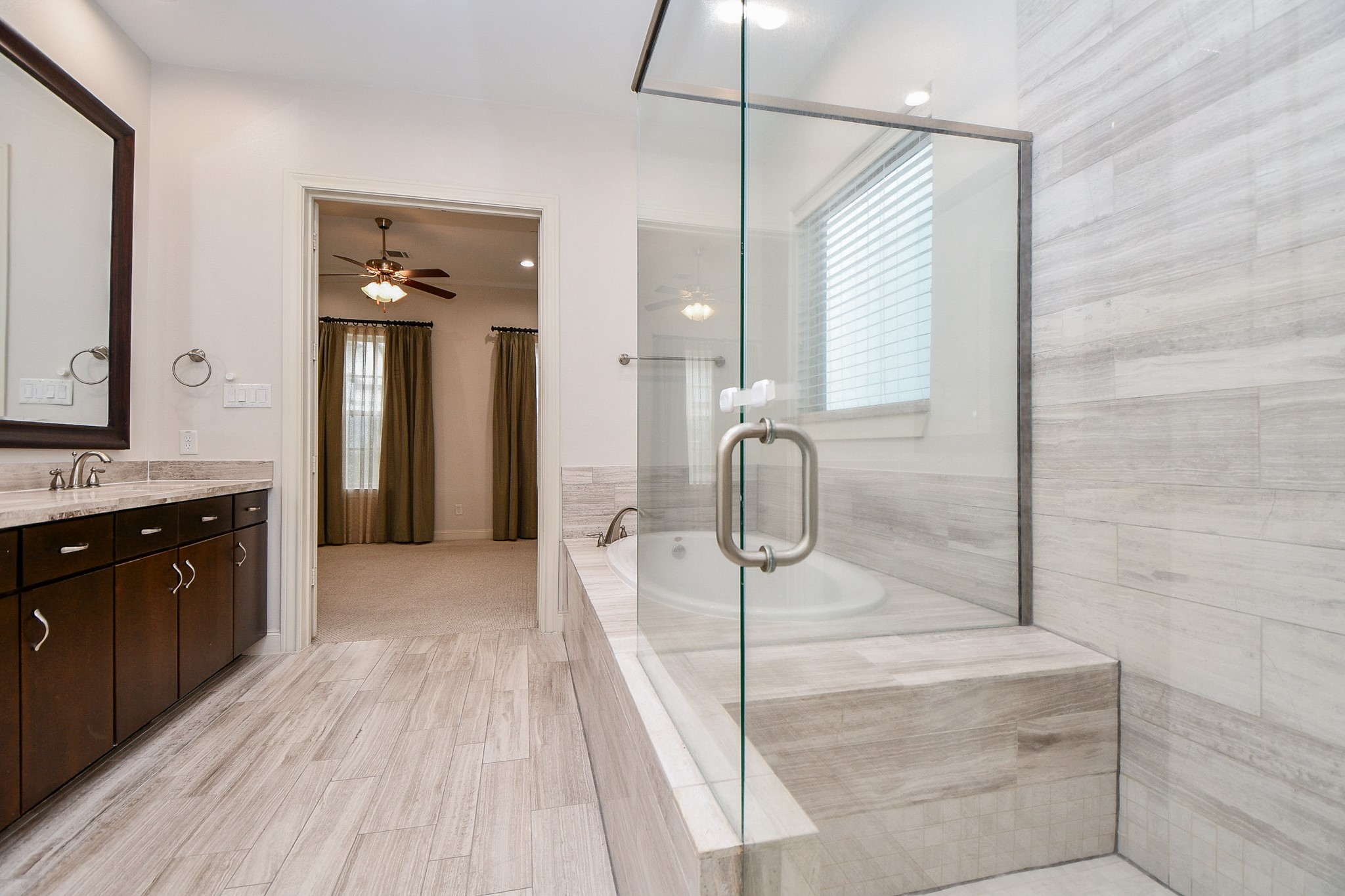709 Delano Street Houston, TX 77003 - Photo 19 of 36 a spacious bathroom with a double vanity sink and a mirror