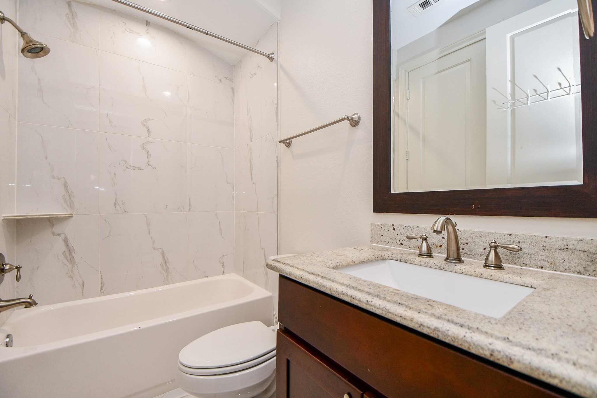 709 Delano Street Houston, TX 77003 - Photo 27 of 36 a bathroom with a granite countertop sink toilet and shower