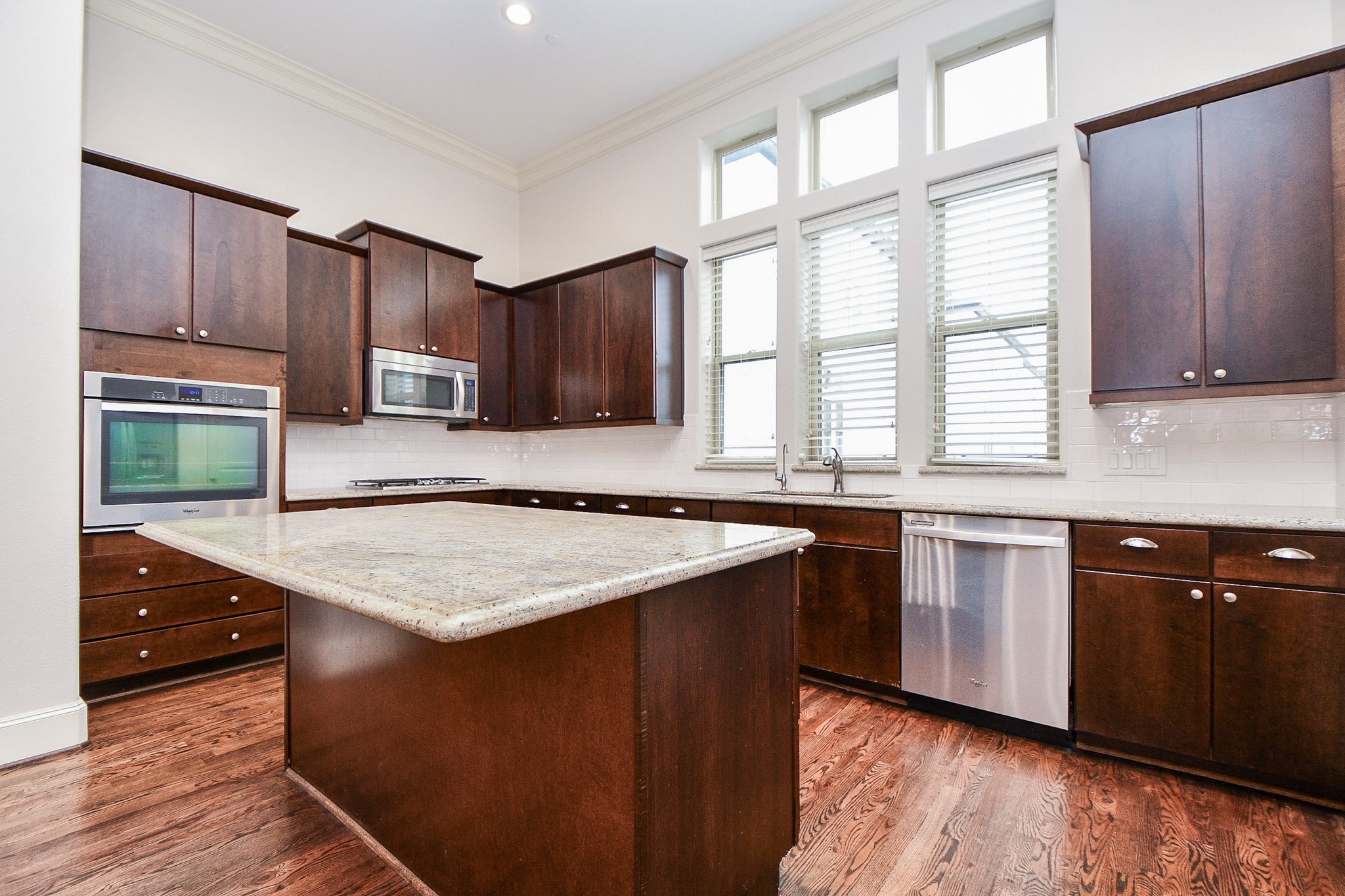709 Delano Street Houston, TX 77003 - Photo 8 of 36 a kitchen with wooden cabinets a sink and a stove