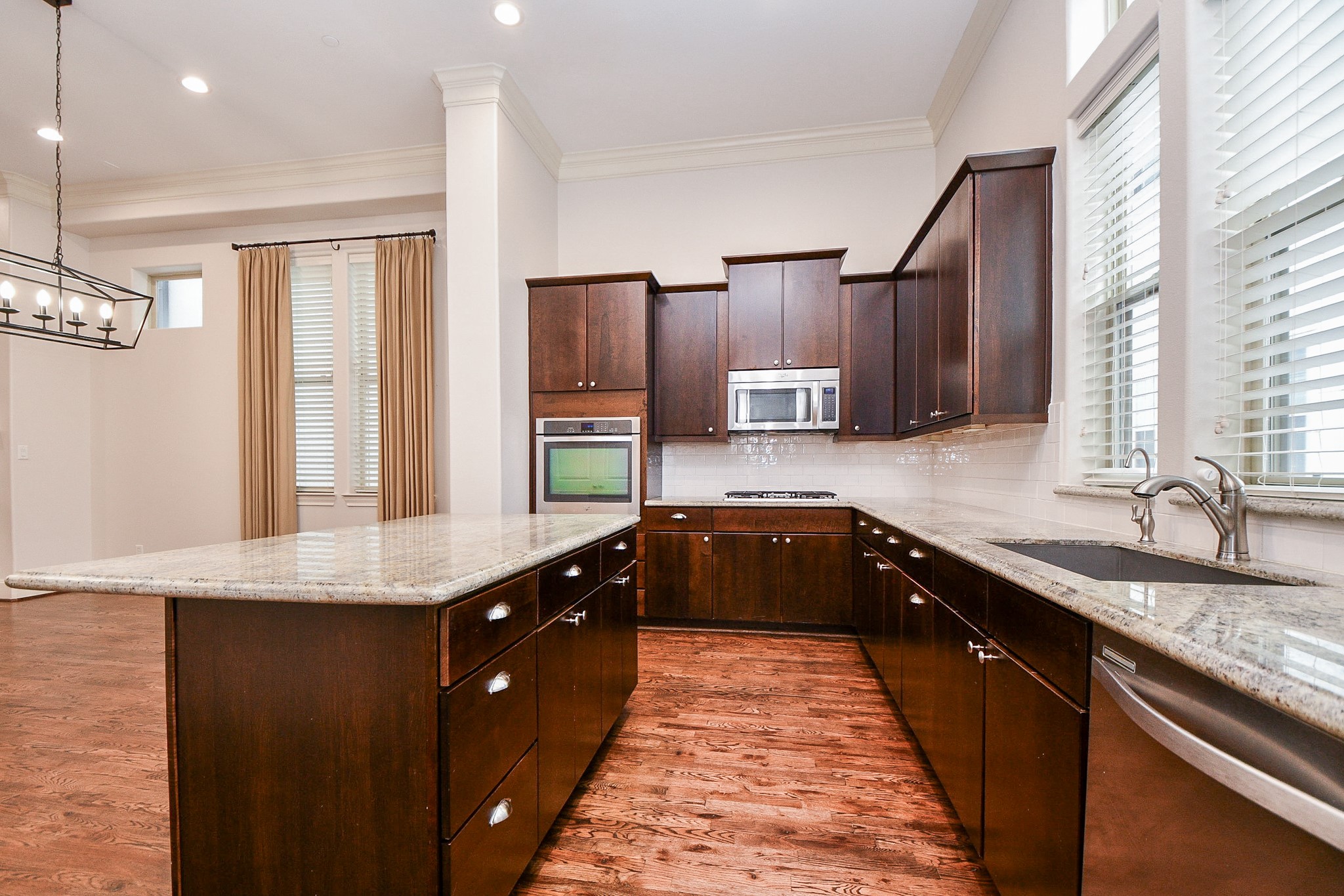 709 Delano Street Houston, TX 77003 - Photo 10 of 36 a kitchen with stainless steel appliances granite countertop a sink a stove and a refrigerator