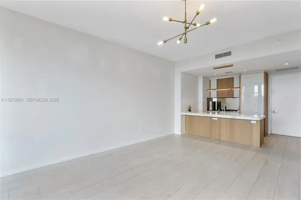 a kitchen with a sink and refrigerator