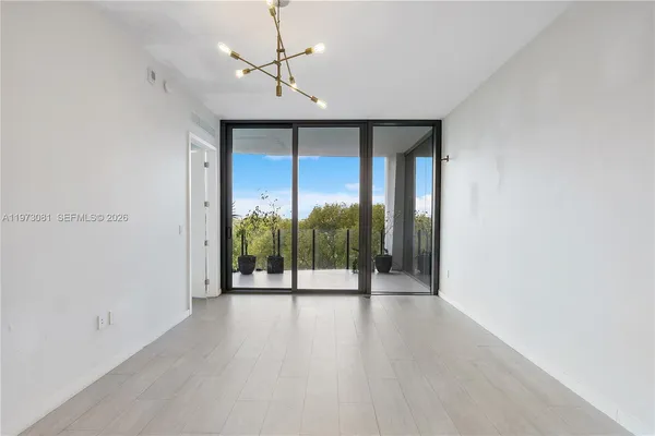 a vase of flowers sitting on a table with chairs