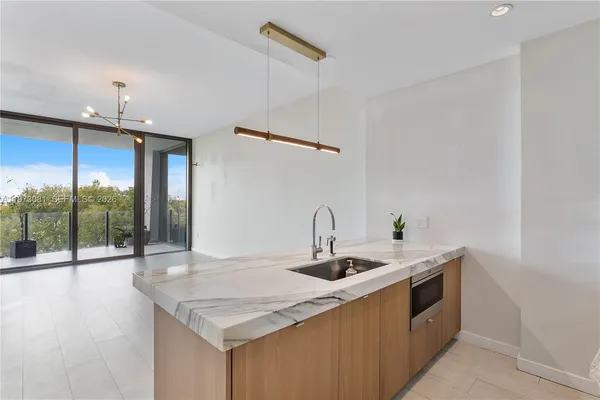 a kitchen with a sink a counter top space and furniture