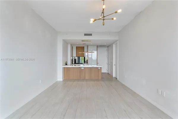 a living room with furniture and a mirror