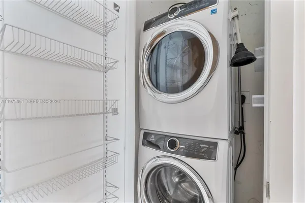 a view of living room with furniture and floor to ceiling windows