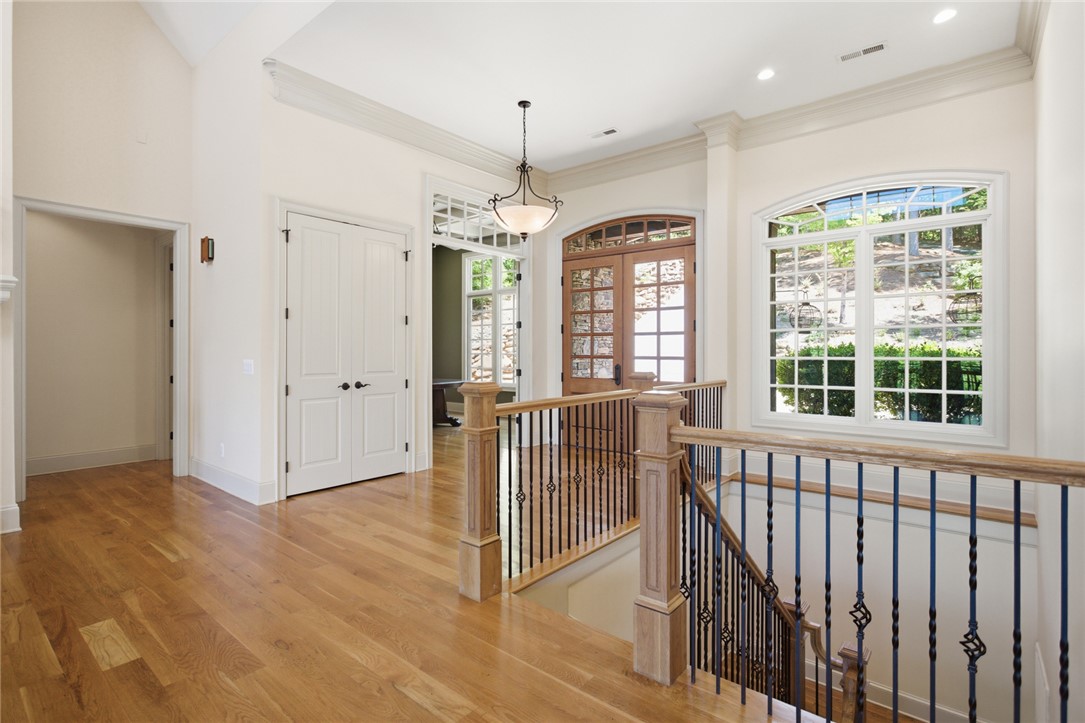 130 River Ridge Road Sunset, SC 29685 - Photo 5 of 47 A grand entrance with warm hardwood flooring and an elegant wrought iron staircase sets a refined tone.