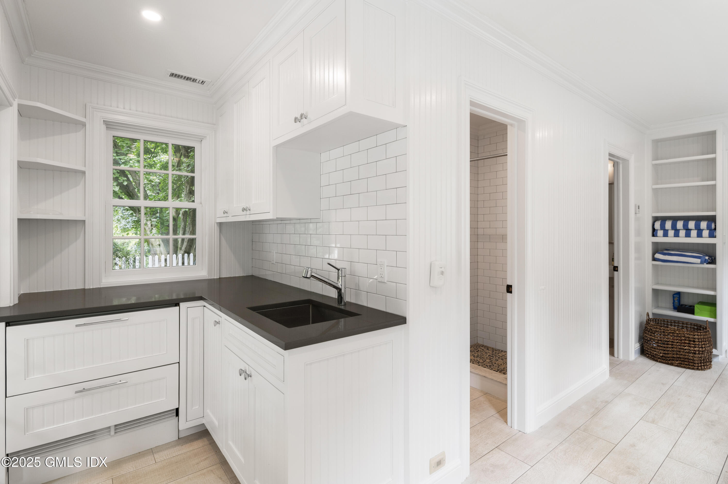40 Ridgeview Avenue Greenwich, CT 06830 - Photo 30 of 38 a kitchen with granite countertop white cabinets and window
