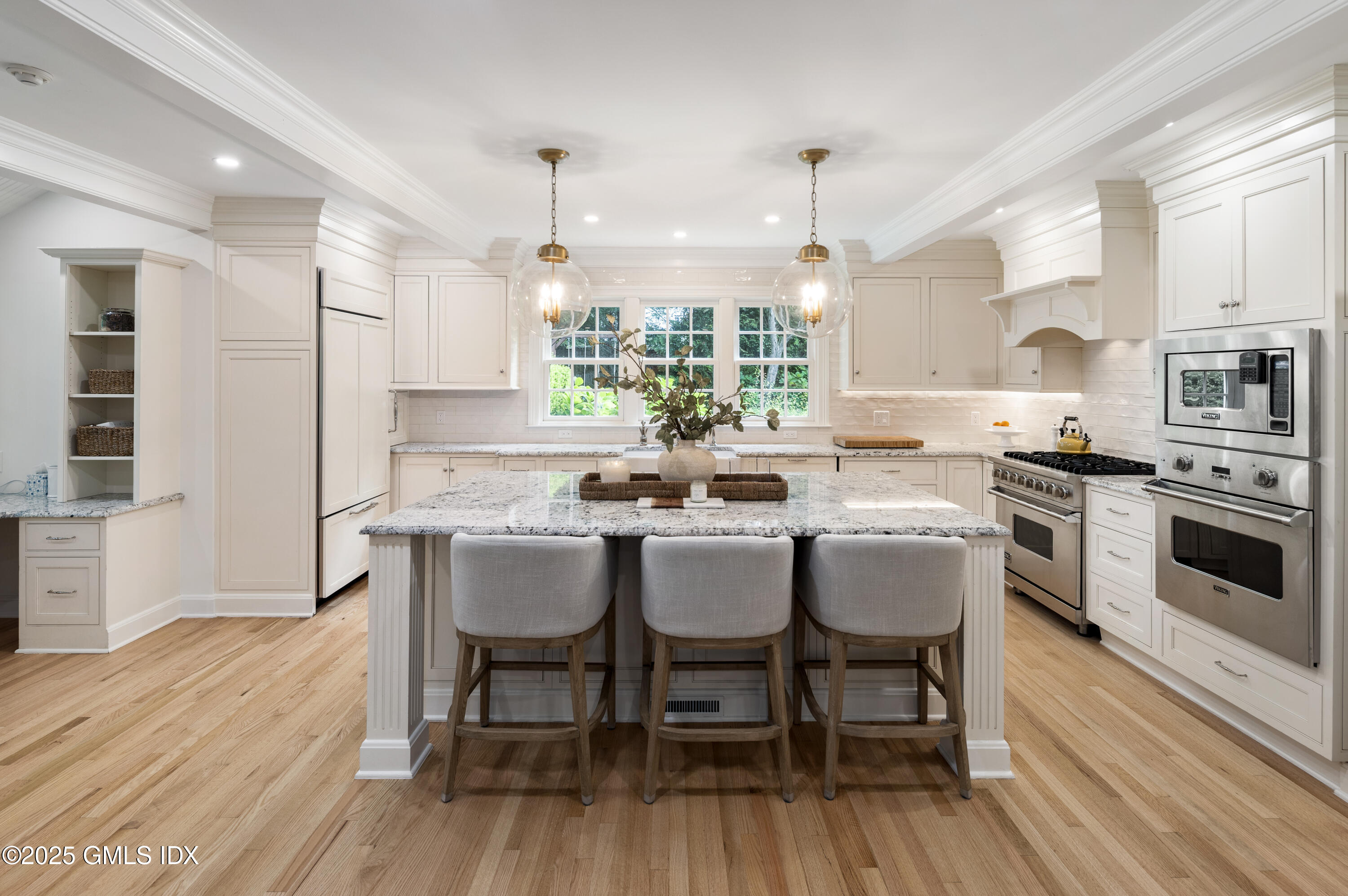 40 Ridgeview Avenue Greenwich, CT 06830 - Photo 7 of 38 a kitchen with stainless steel appliances a dining table chairs stove microwave and cabinets