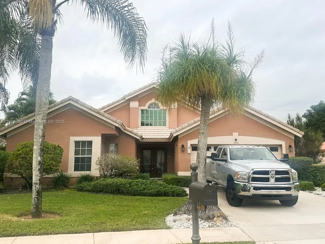 a front view of a house with a garden and plants