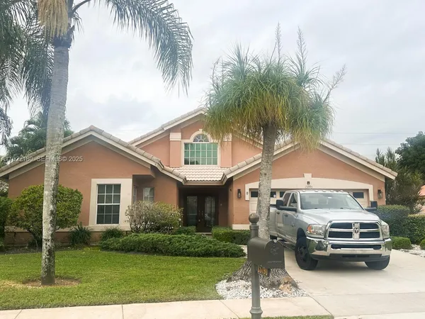 a front view of a house with a garden and plants