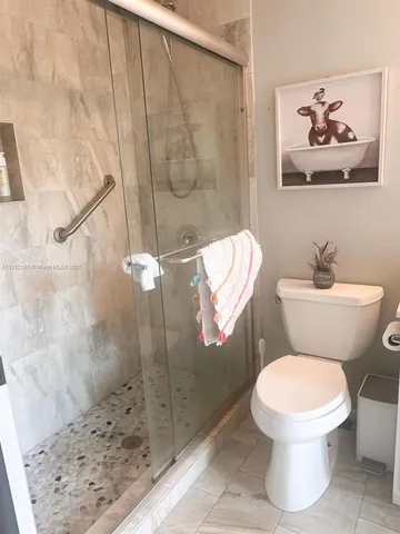 a white toilet sitting next to a bathroom sink