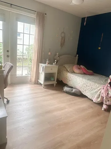 a spacious bedroom with a bed and large windows