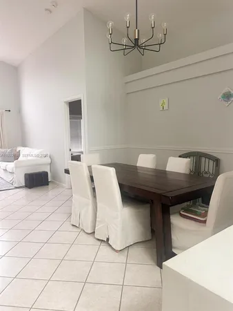 a living room with a couch and a chandelier