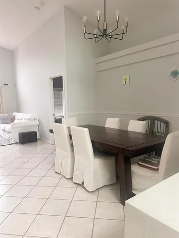 a living room with a couch and a chandelier