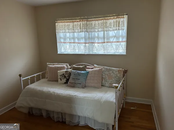 a bedroom with a bed and window