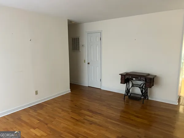 a view of an empty room and wooden floor