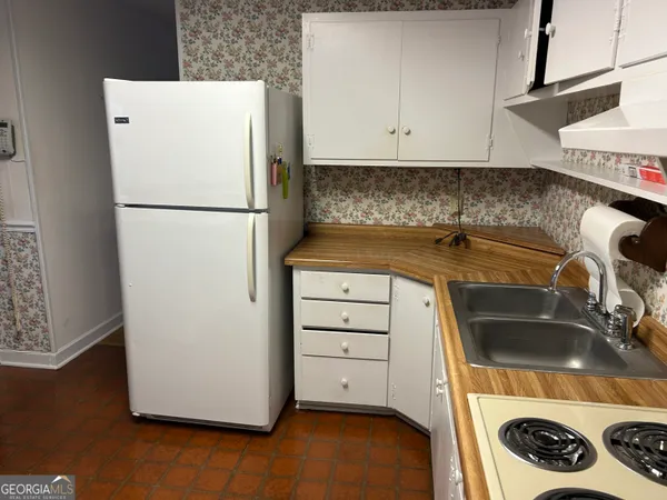 a kitchen with a refrigerator and a sink