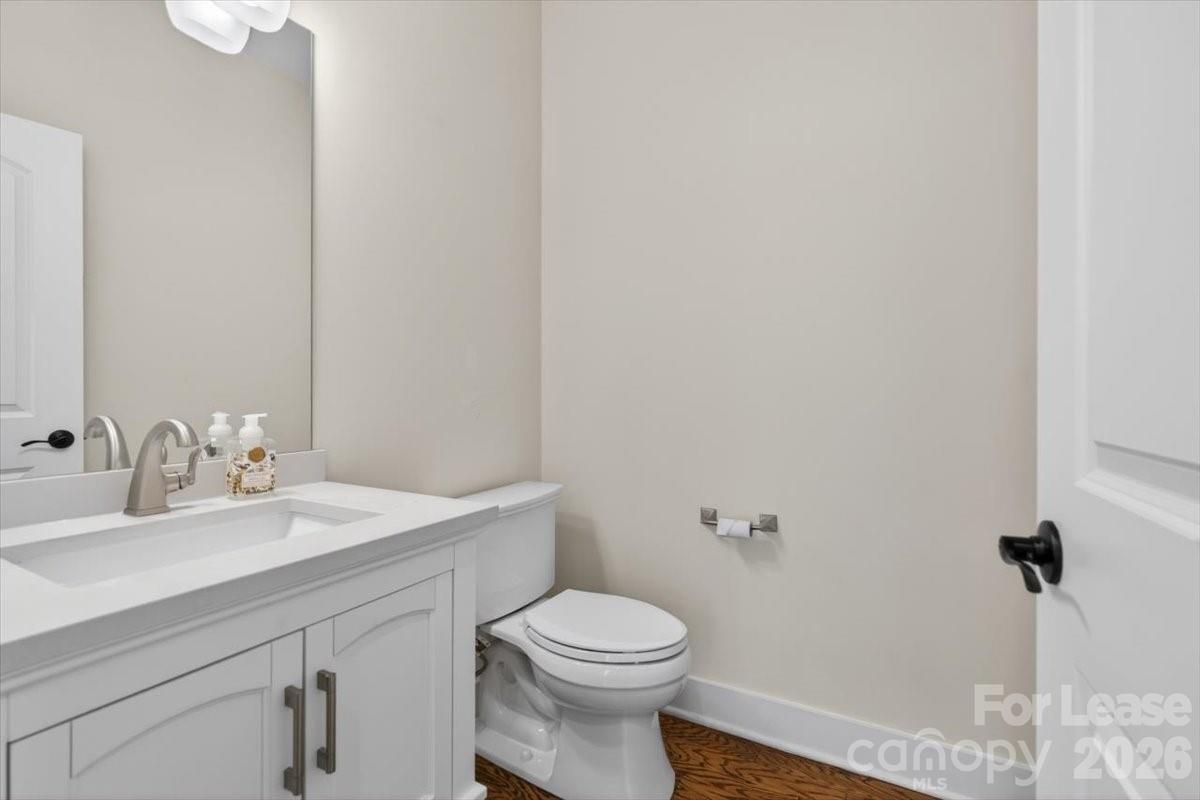 5201 Valley Stream Road Charlotte, NC 28209 - Photo 12 of 47 a bathroom with a sink a toilet and a mirror
