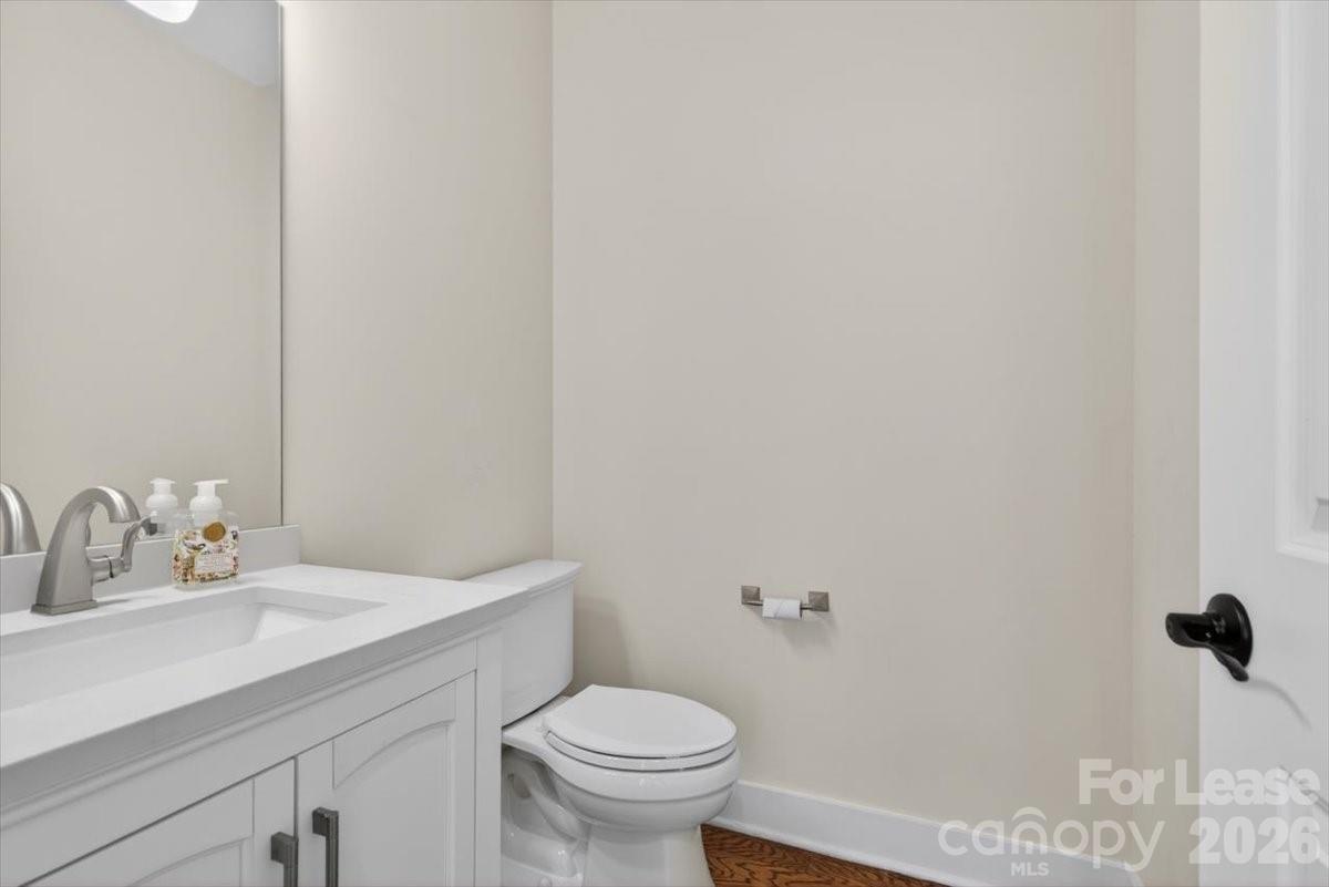 5201 Valley Stream Road Charlotte, NC 28209 - Photo 14 of 47 a bathroom with a sink a toilet and a mirror