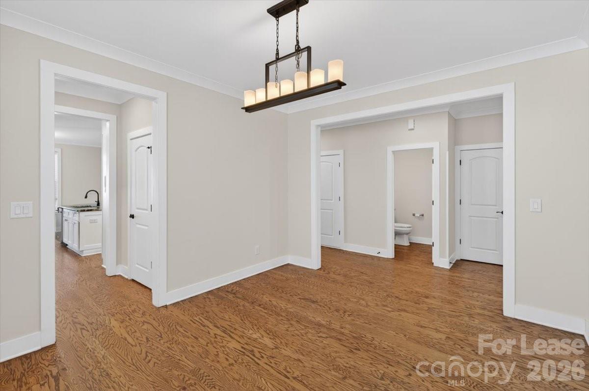 5201 Valley Stream Road Charlotte, NC 28209 - Photo 23 of 47 a view of a room with wooden floor and white walls