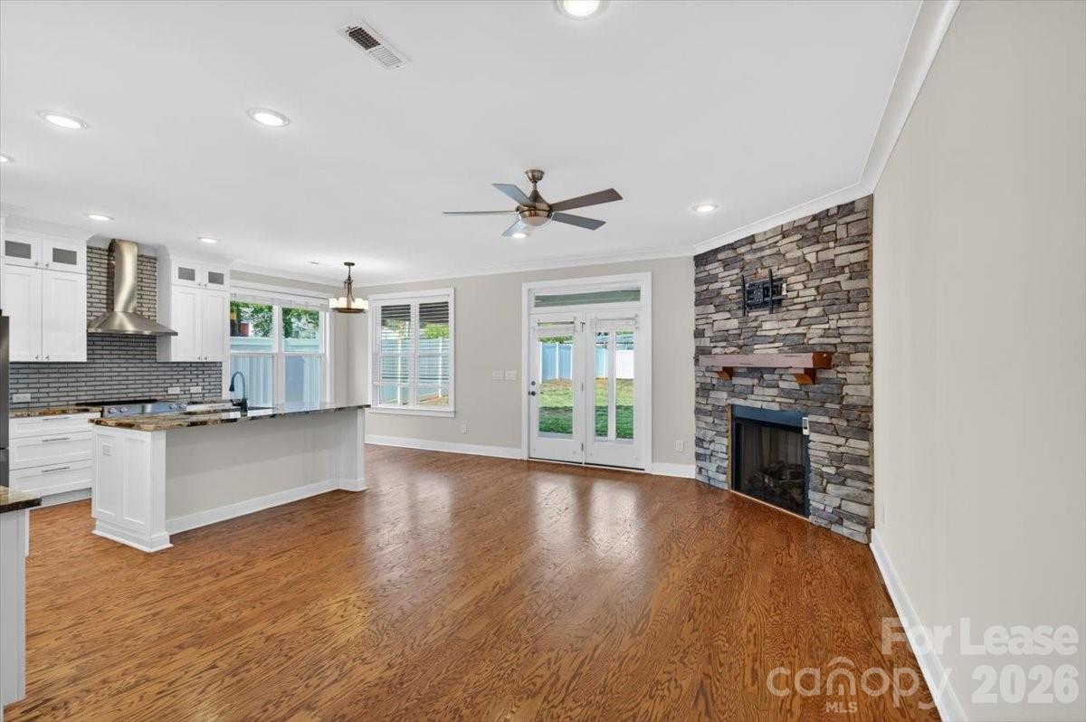 5201 Valley Stream Road Charlotte, NC 28209 - Photo 32 of 47 a open kitchen with granite countertop a stove top oven a sink a counter space and cabinets