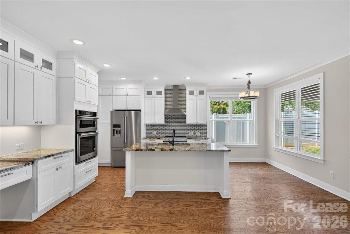 5201 Valley Stream Road Charlotte, NC 28209 - Photo 35 of 47 a large kitchen with kitchen island a large counter top stainless steel appliances and cabinets