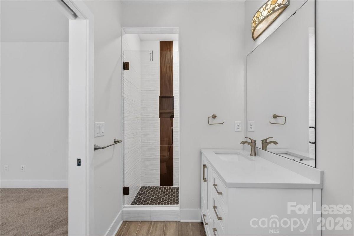 5201 Valley Stream Road Charlotte, NC 28209 - Photo 4 of 47 a bathroom with a sink and a mirror