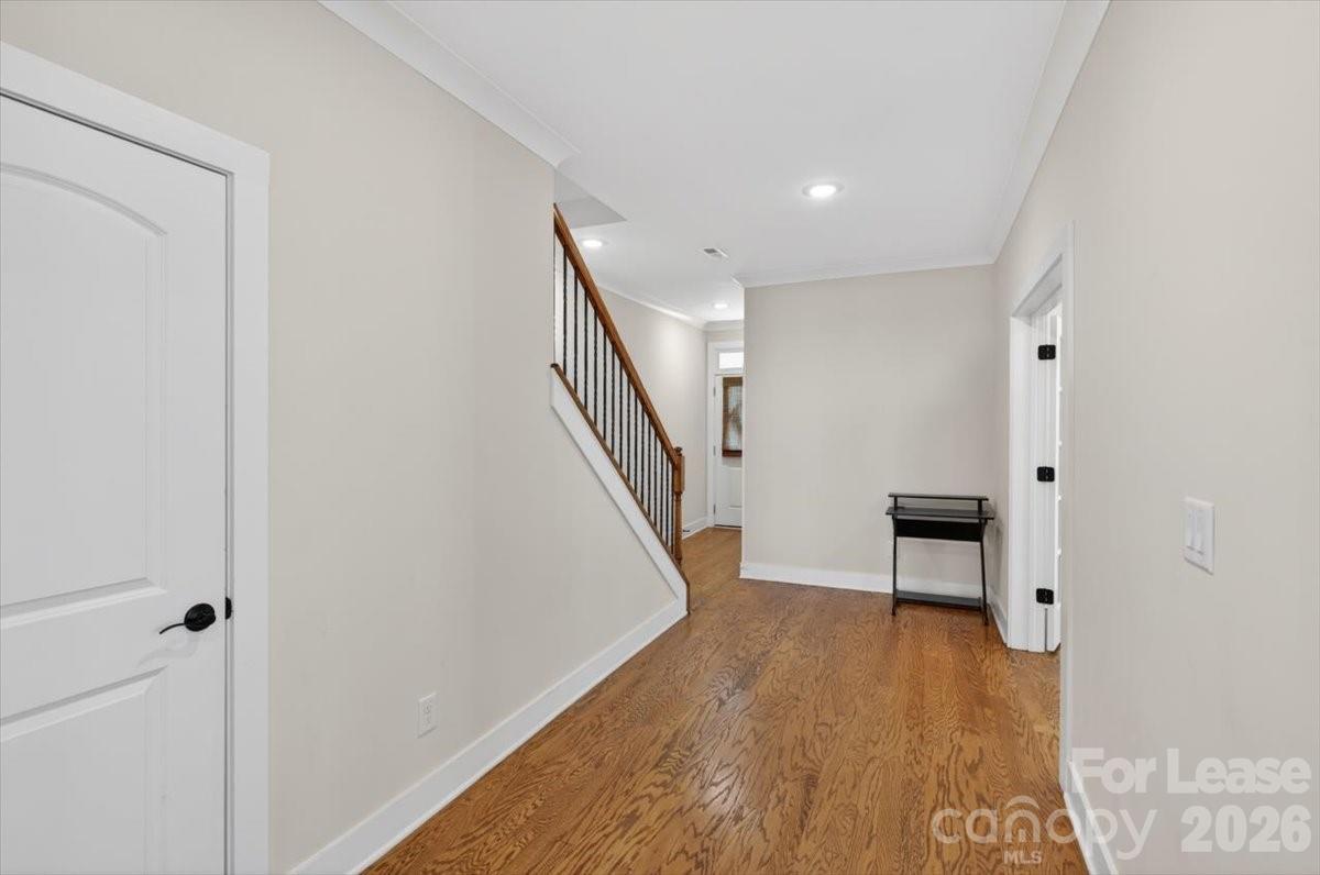 5201 Valley Stream Road Charlotte, NC 28209 - Photo 47 of 47 a view of a hallway with wooden floor and a bathroom
