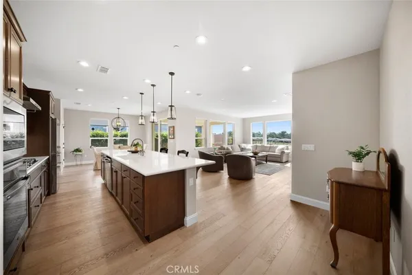 a kitchen with counter top space appliances and wooden floor