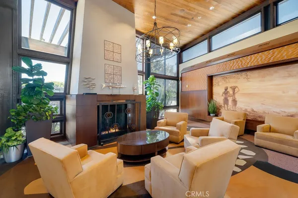 a view of a dining room with furniture large windows and wooden floor