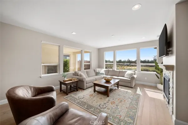 a living room with furniture large window and a flat screen tv