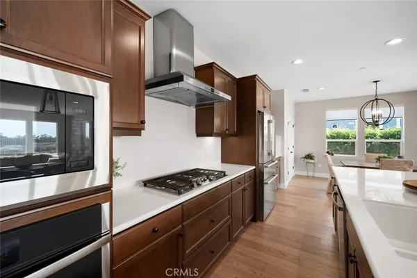 a kitchen with cabinets and stainless steel appliances