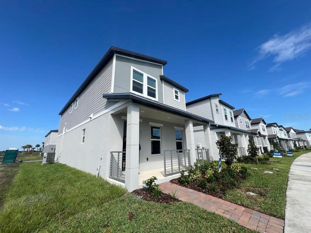 4638 Homestead Trail St. Cloud, FL 34772 - Photo 1 of 30 a view of a white house next to a yard with big trees