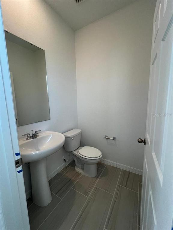 4638 Homestead Trail St. Cloud, FL 34772 - Photo 15 of 30 a bathroom with a sink toilet and a mirror