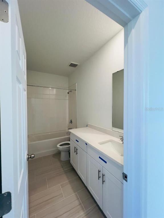 4638 Homestead Trail St. Cloud, FL 34772 - Photo 24 of 30 a bathroom with a granite countertop sink a toilet and a bathtub