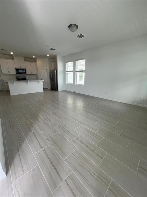 4638 Homestead Trail St. Cloud, FL 34772 - Photo 5 of 30 wooden floor in an empty room with a window