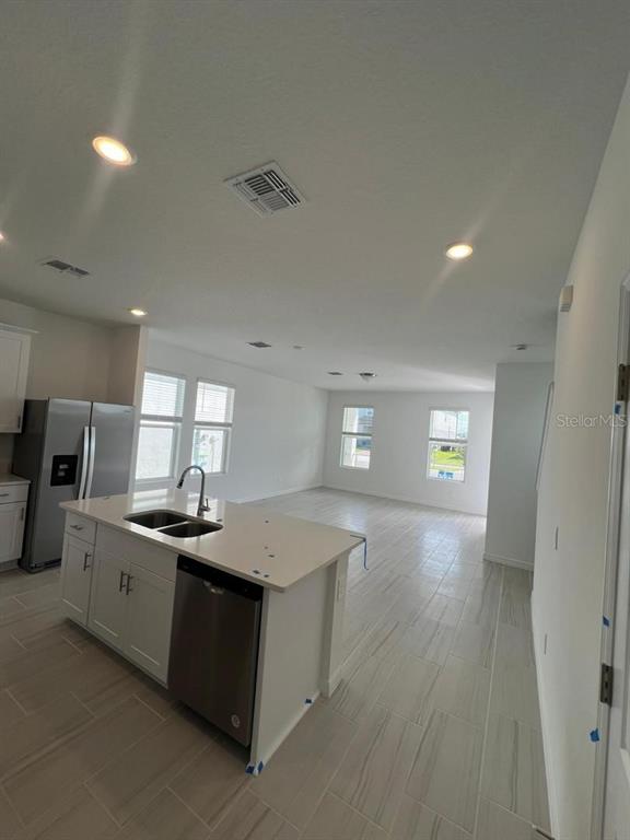 4638 Homestead Trail St. Cloud, FL 34772 - Photo 10 of 30 a kitchen with stainless steel appliances granite countertop a sink stove and refrigerator