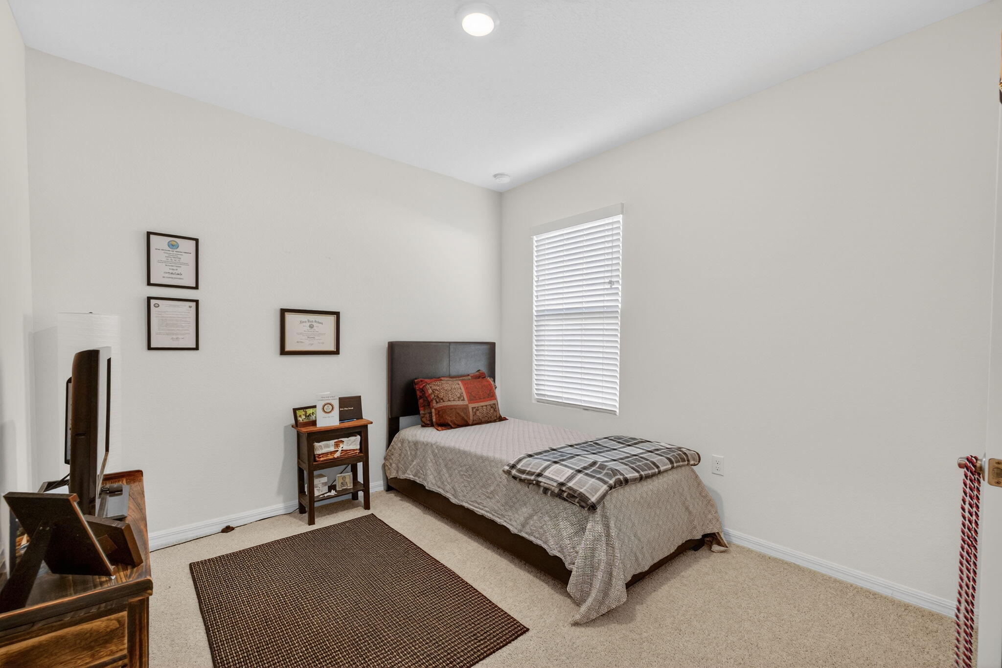 5221 Armina Place Fort Pierce, FL 34951 - Photo 25 of 40 a bedroom with a bed and a flat screen tv