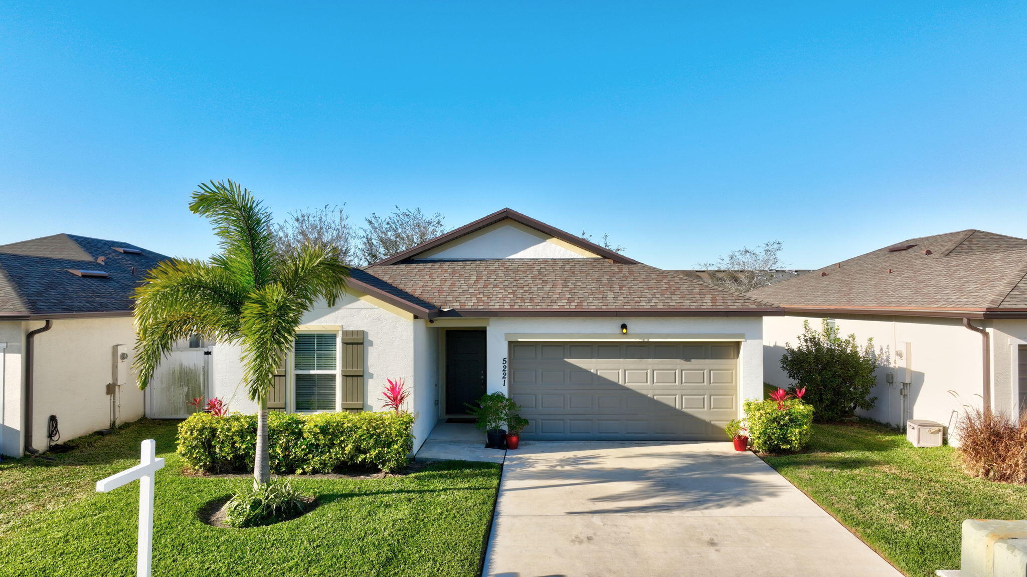 5221 Armina Place Fort Pierce, FL 34951 - Photo 31 of 40 a front view of a house with a yard and garage