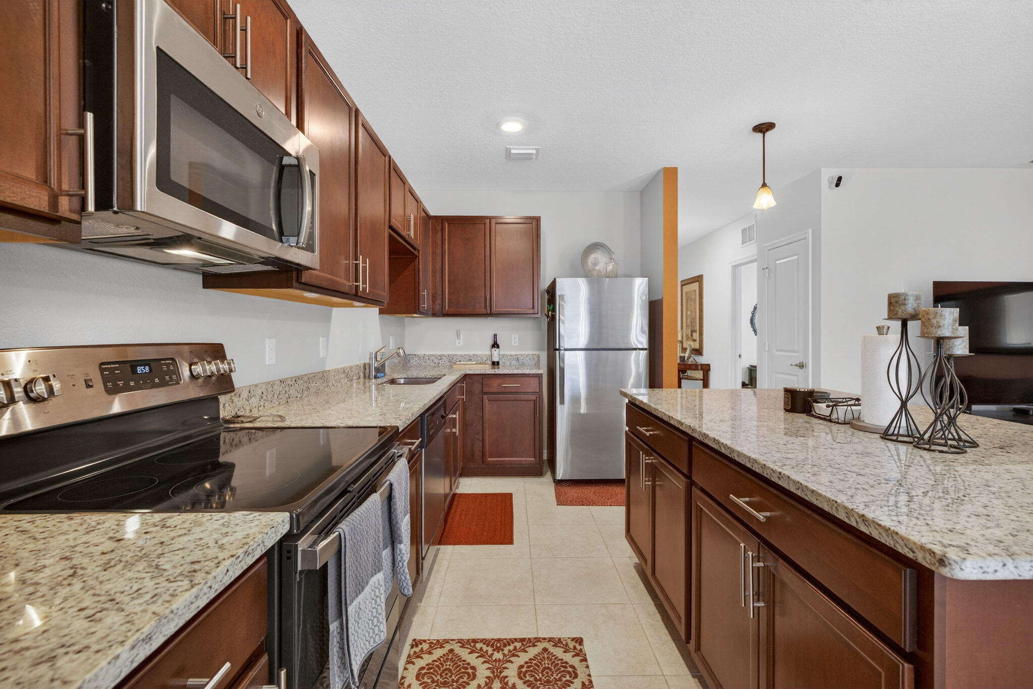 5221 Armina Place Fort Pierce, FL 34951 - Photo 9 of 40 a kitchen with stainless steel appliances granite countertop a sink a stove and a refrigerator